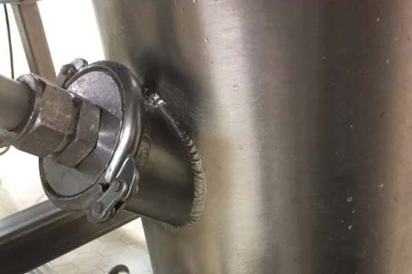Close view of a sanitary stainless fitting and weld
