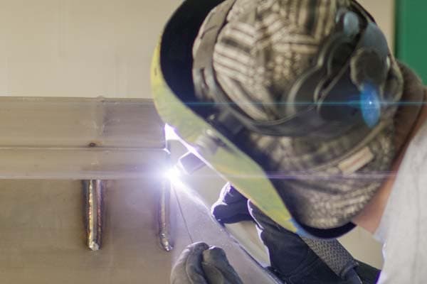 Welder completing precision work on stainless material